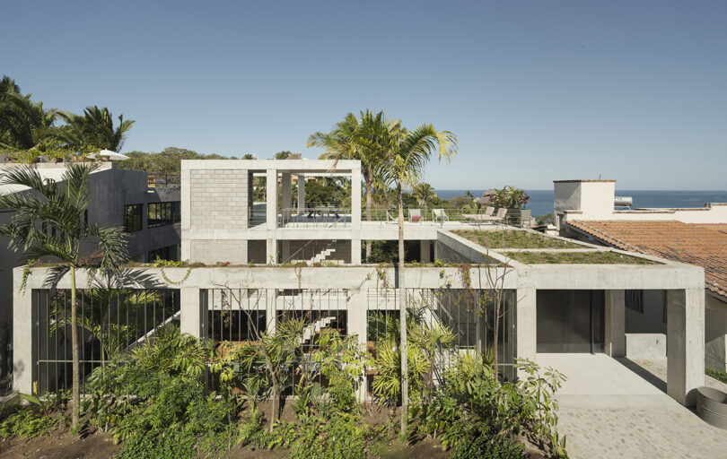 Front of NICO with glimpses of two floating staircases and the ocean in the background.
