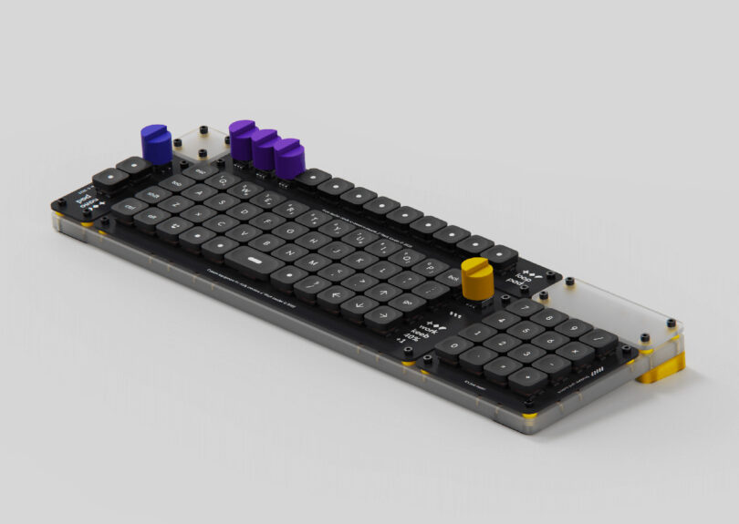 Overhead angled view of Creator Board XL keyboard showing its aligned grid layout and outfitted with numeric keypad attached and all four rotary dials, one blue, three in purple, and the far right in yellow.