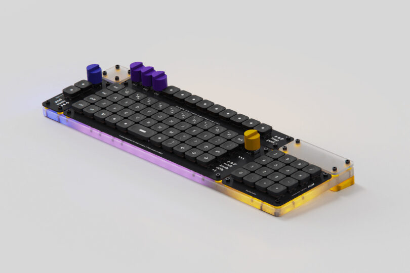 Angled view of Creator Board XL keyboard showing its aligned grid layout and outfitted with numeric keypad attached and all four rotary dials, one blue, three in purple, and the far right in yellow.