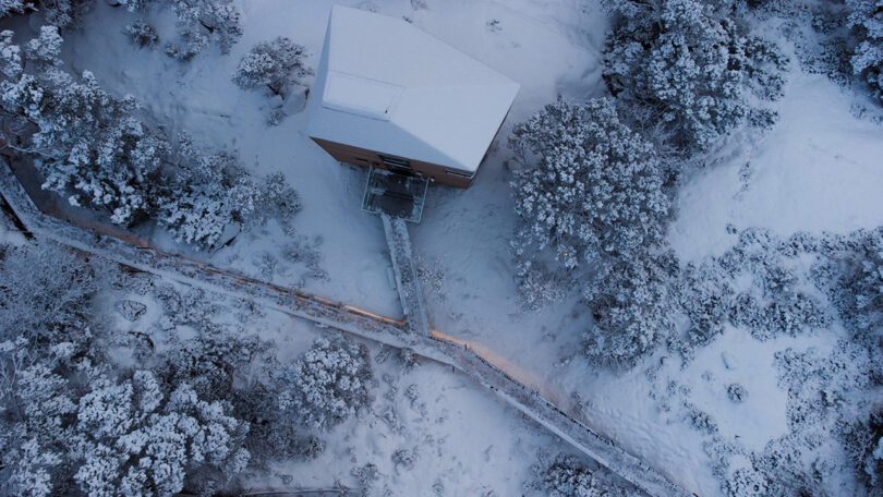 Overhead photo of The Borders Lodge during winter, with the entire roof blanketed in a thick layer of snow.