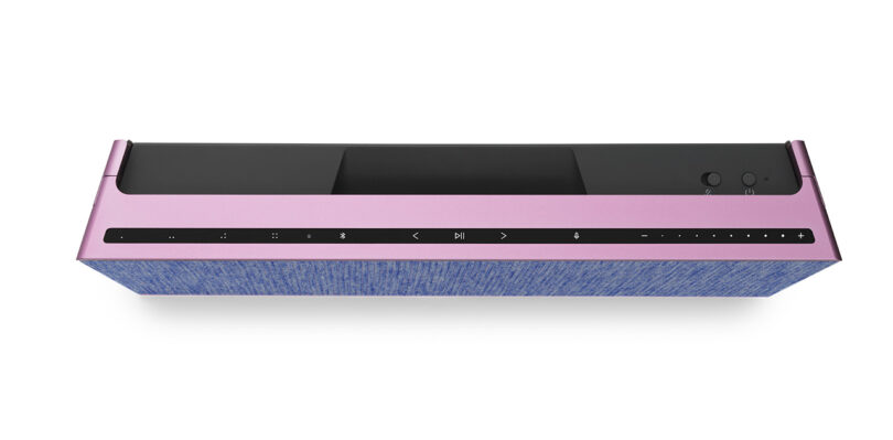 Top view of Fall 2023 Atelier Editions Beosound Level wireless speaker in Lilac Twilight color staged against white, with touch panel controls visible across black Touch Bar controls.