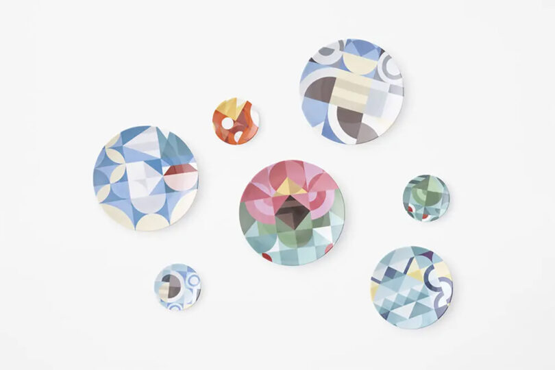 A spread of three full size plates, one salad plate, and three small plates each covered in a geometric Pokemon-themed design photographed against a white backdrop.