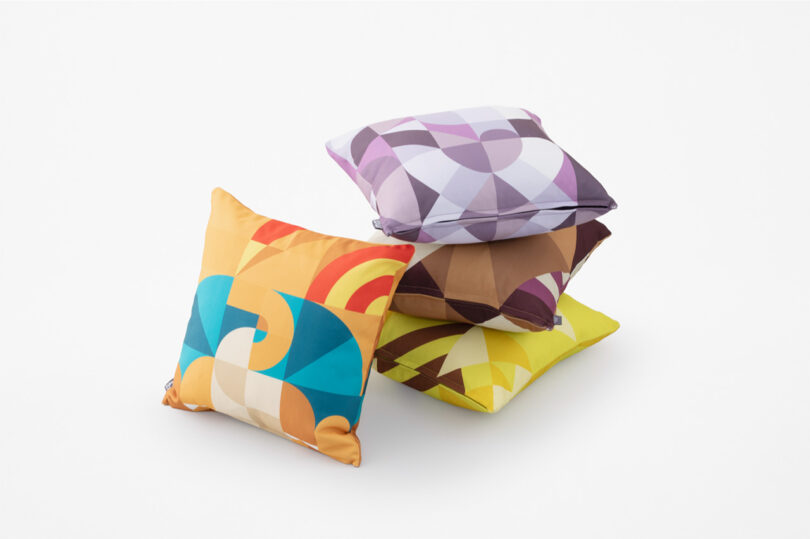 Four stacked Pokemon Mosaic pillows staged on white floor and background.