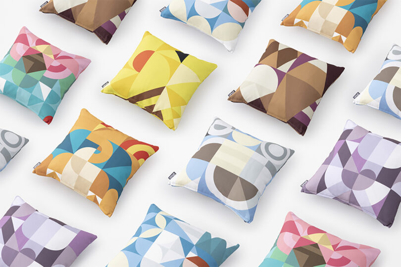Diagonal grid of Pokemon Mosaic collection pillows with varying abstract designs derived from the colors of the Pokemon bestiary.