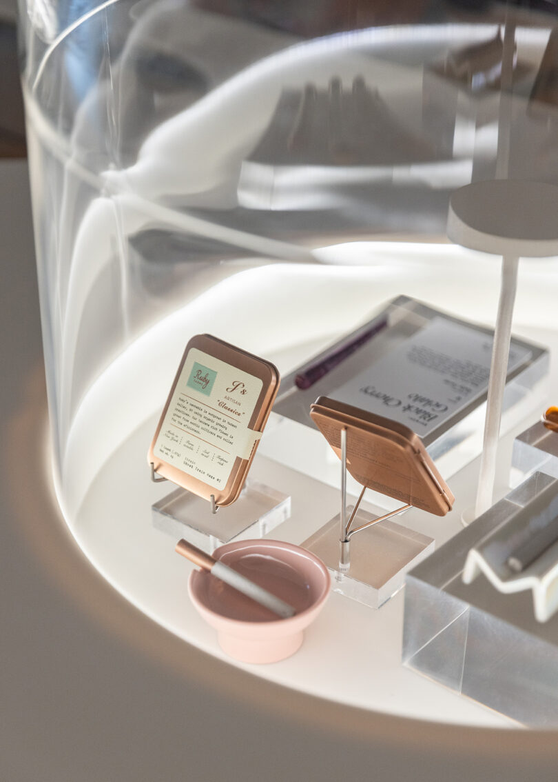 Detail of display case with pre-rolls, vapes, and small ceramic ashtray underneath the clear glass case.