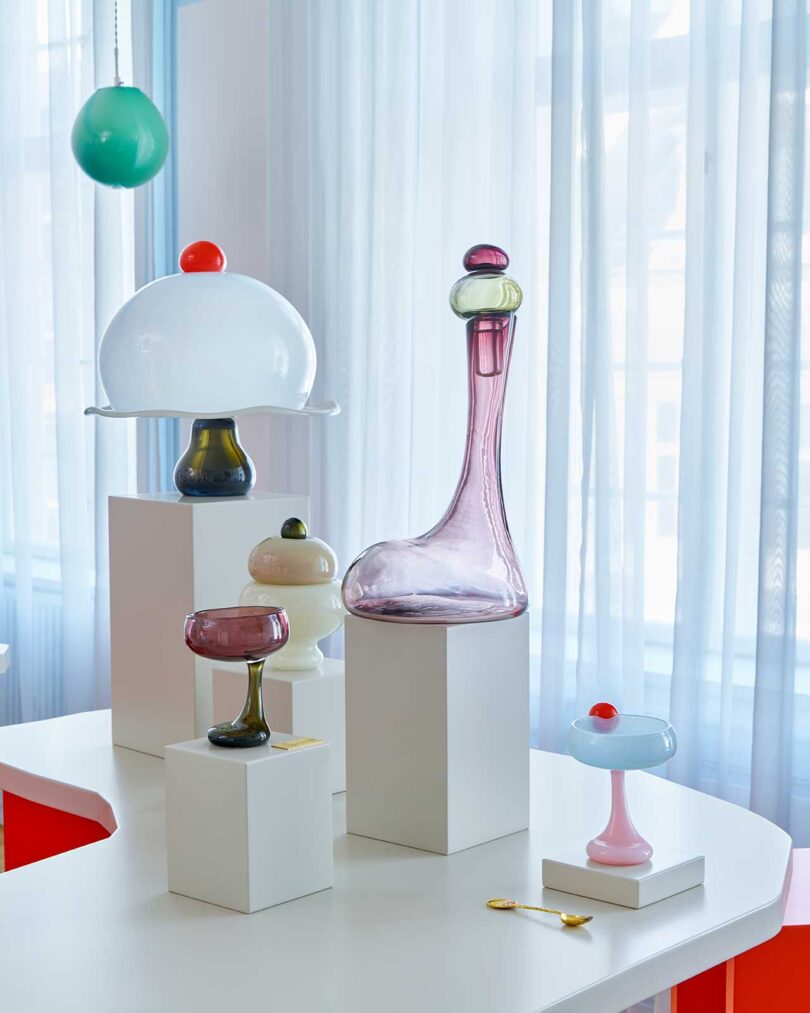 interior room featuring multiple displays of colorful glass objects and lighting