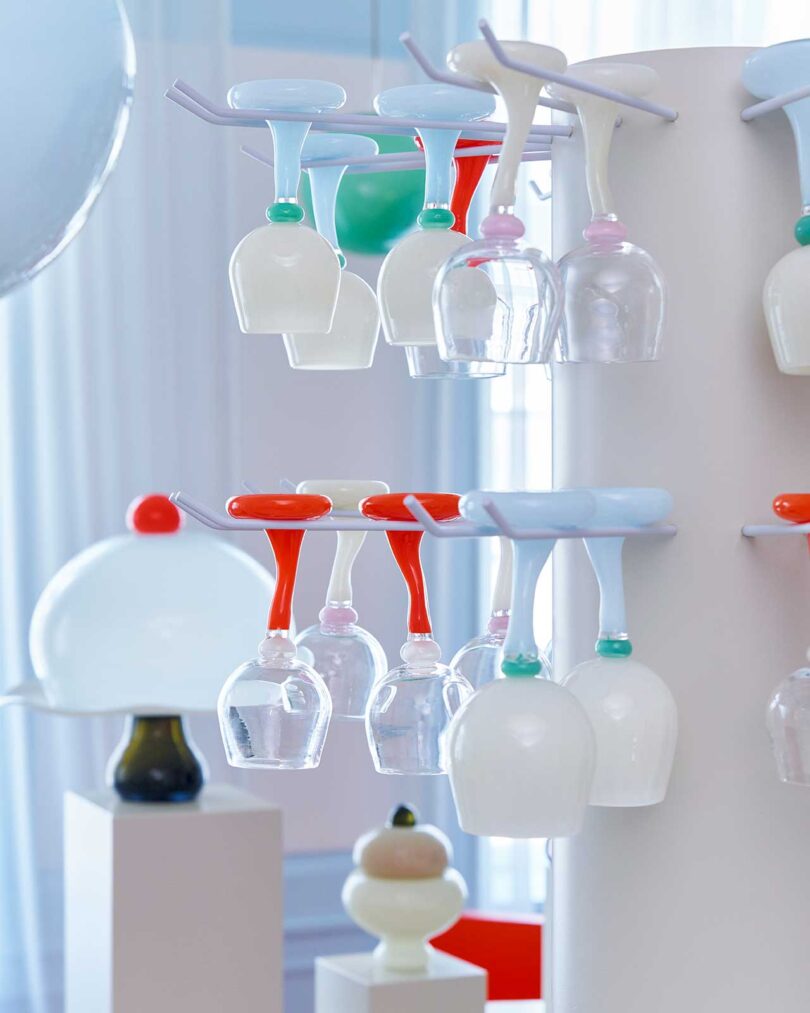 display of quirky and colorful glass goblets hanging upside down