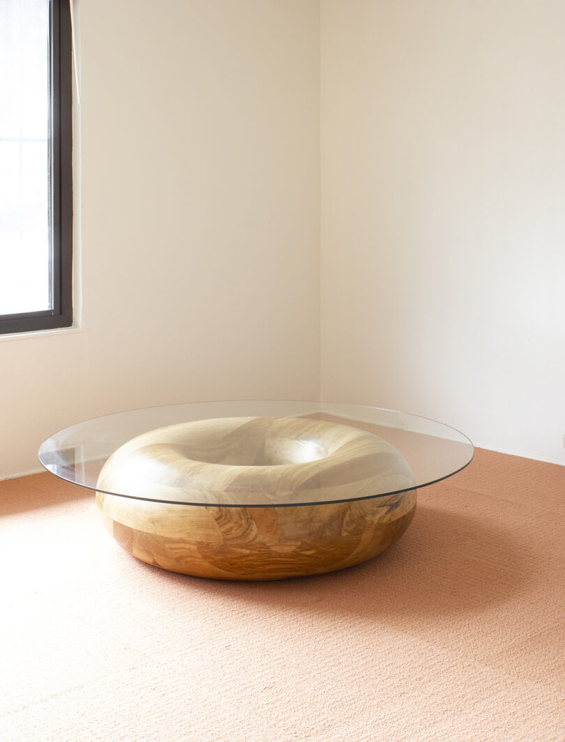 a glass-topped donut-shaped coffee table