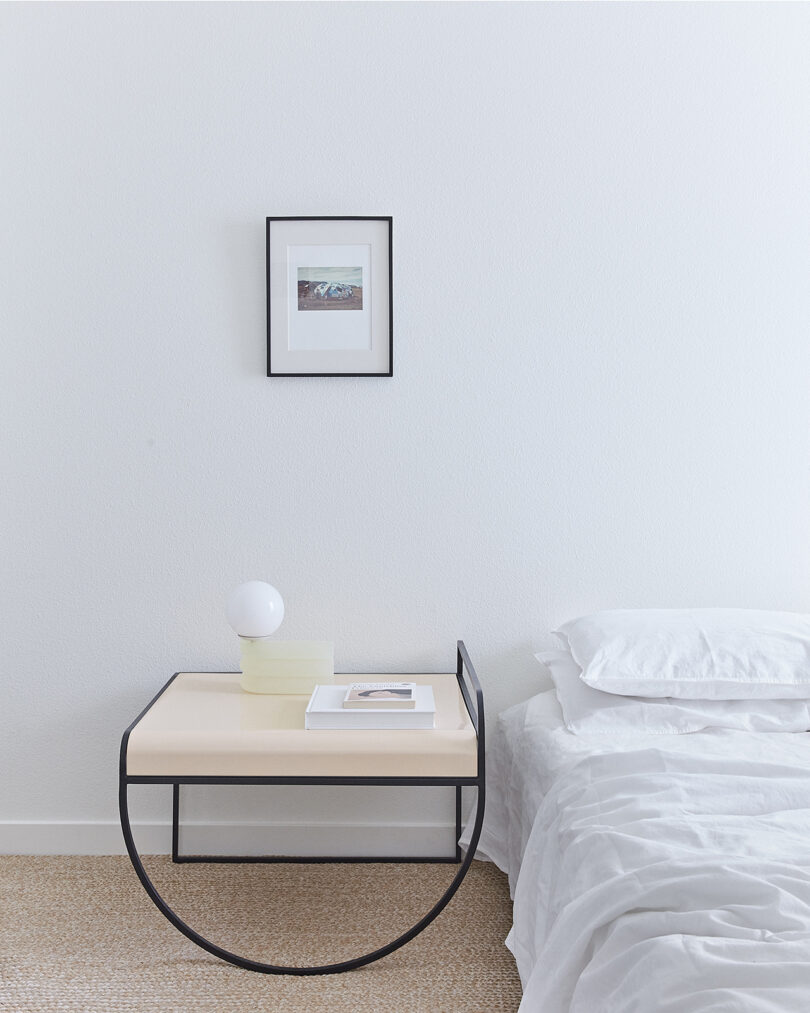 side table with two half-circle shaped leges in a styled bedroom
