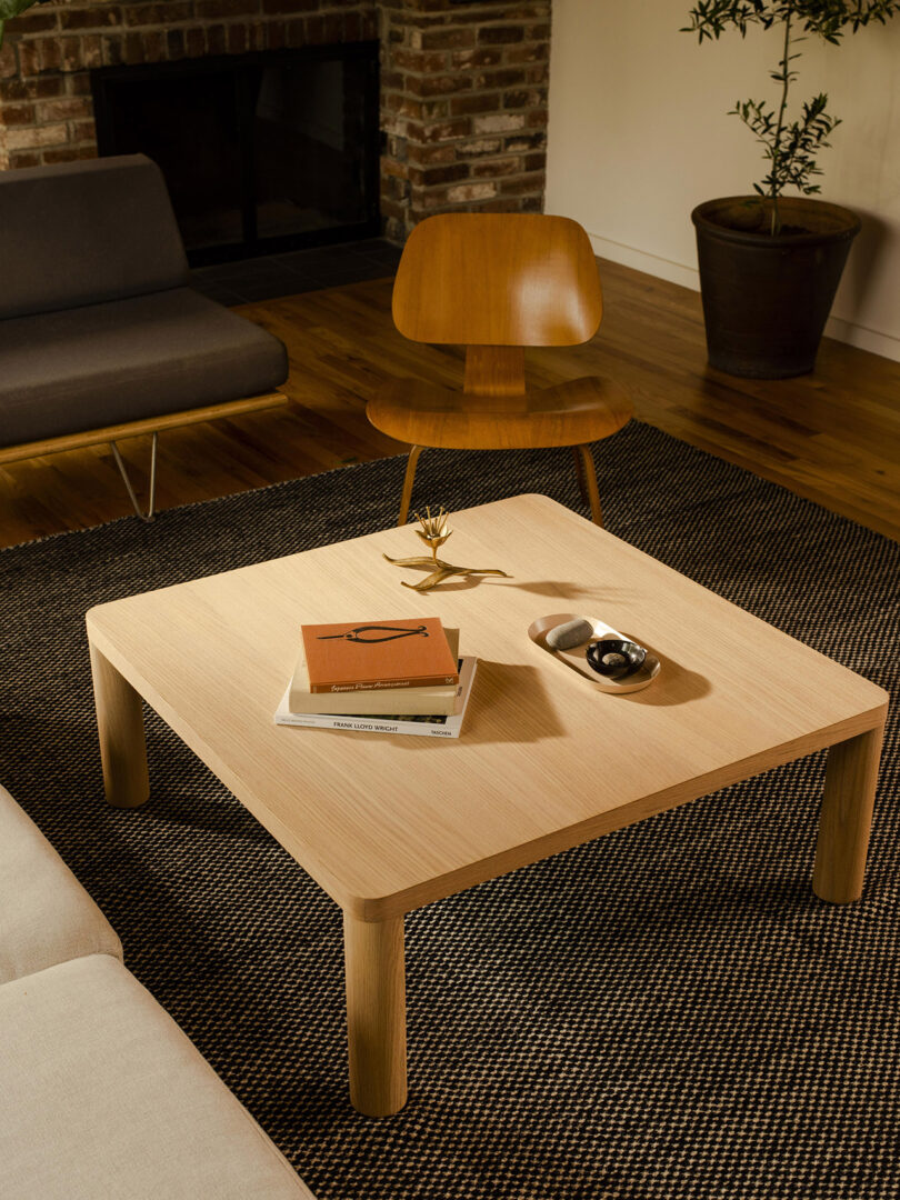 square light wood coffee table in a styled living space