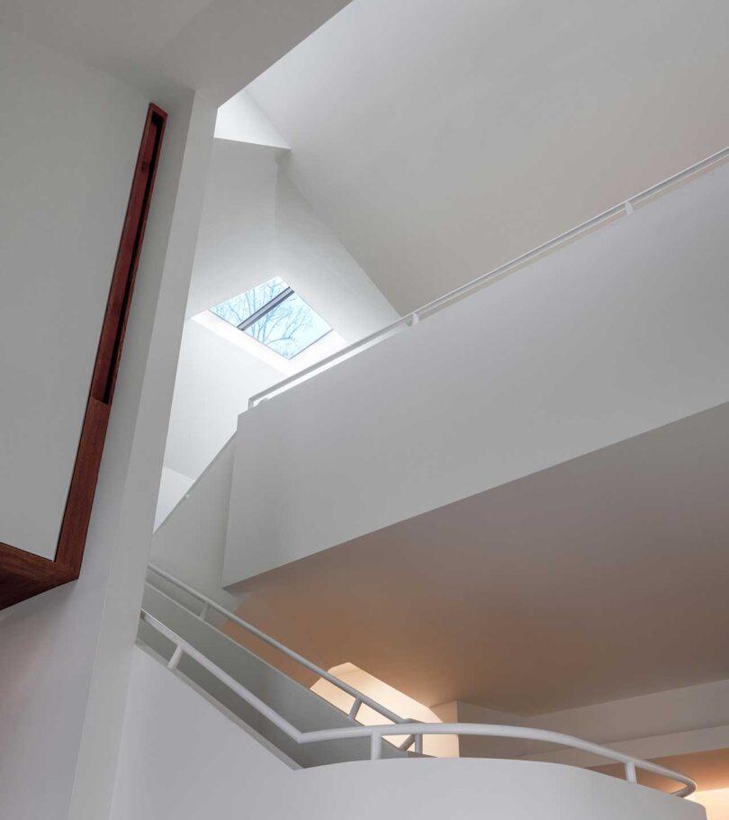up interior view of modern white staircase and floors above