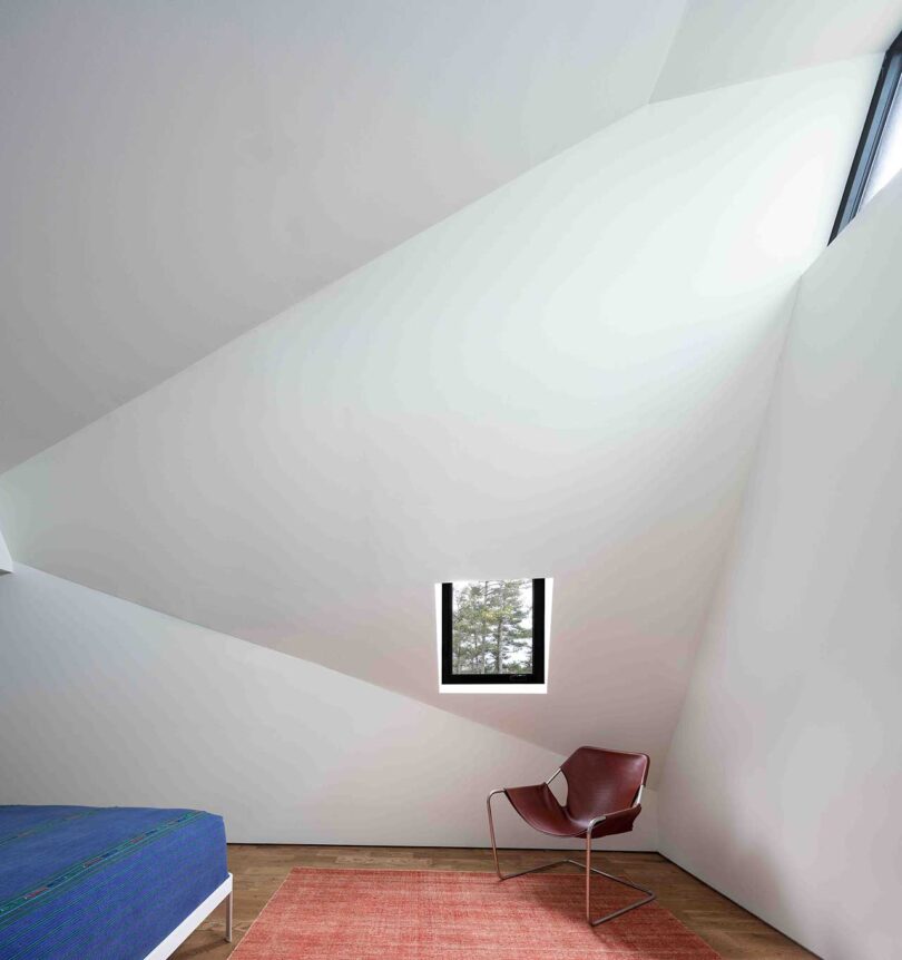 interior view of modern bedroom with angled white ceiling