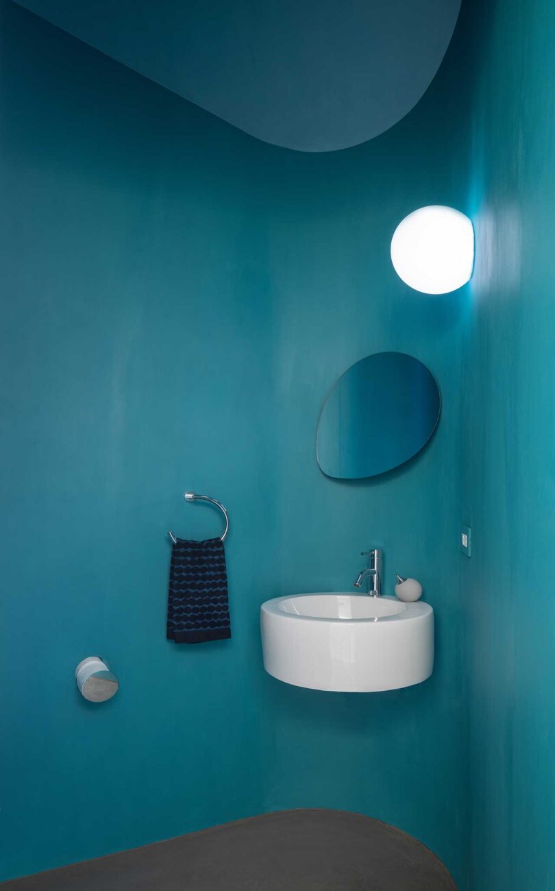 small bathroom interior with teal wall tiles