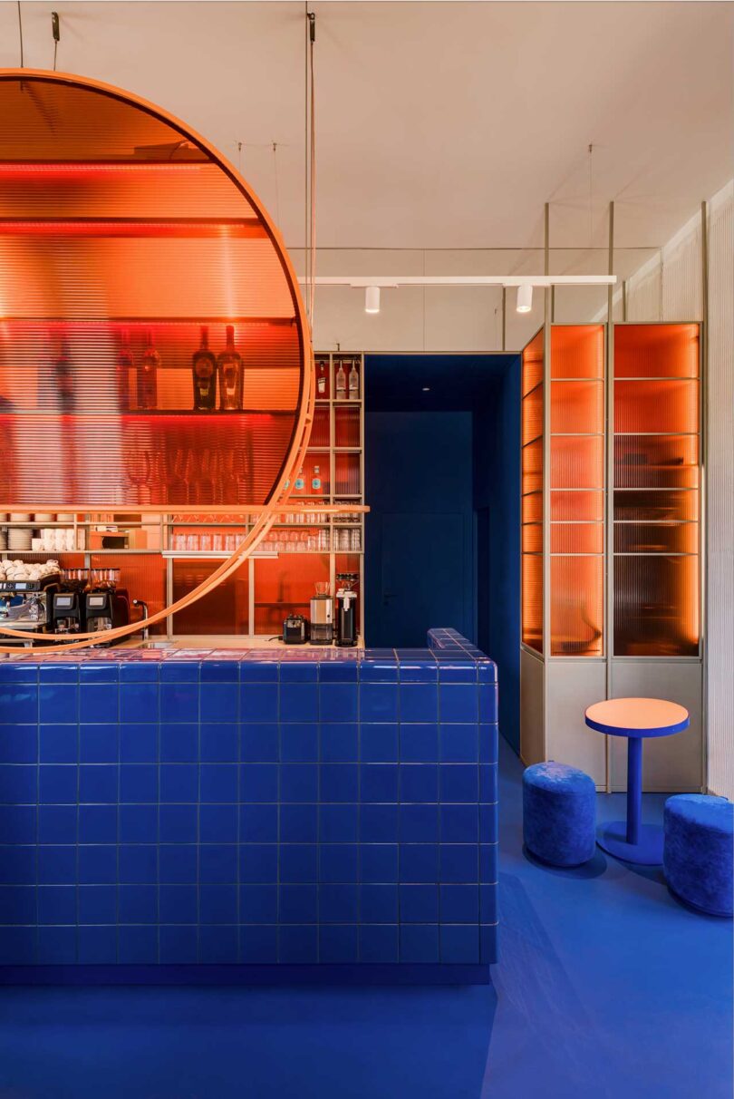commercial restaurant interior with modern aesthetic featuring blue tiled counter and pastries stacked on shelving