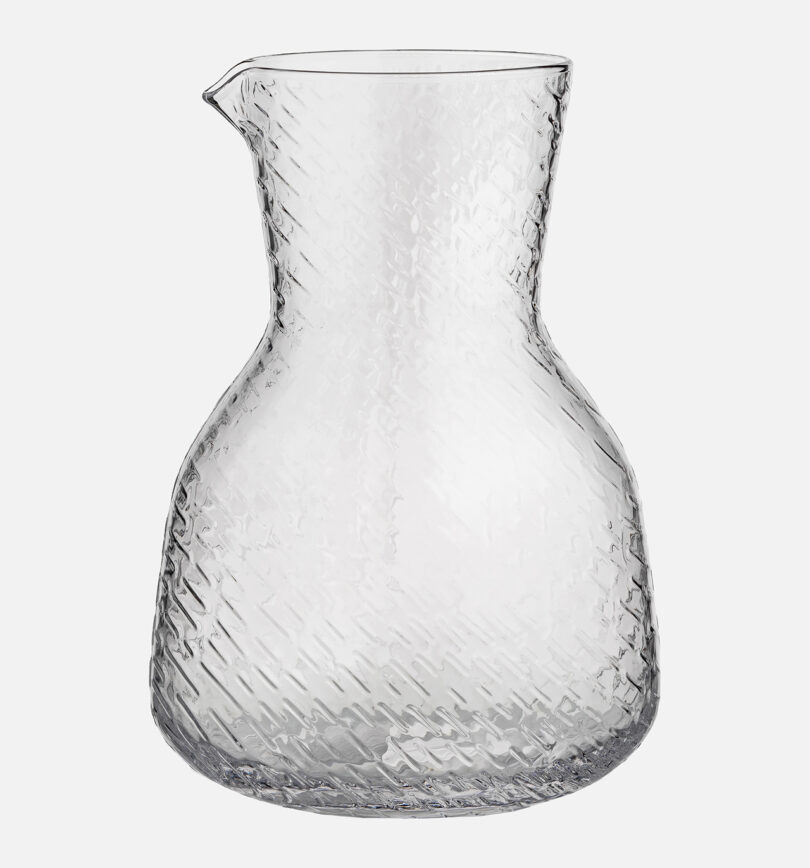 clear glass carafe on white background