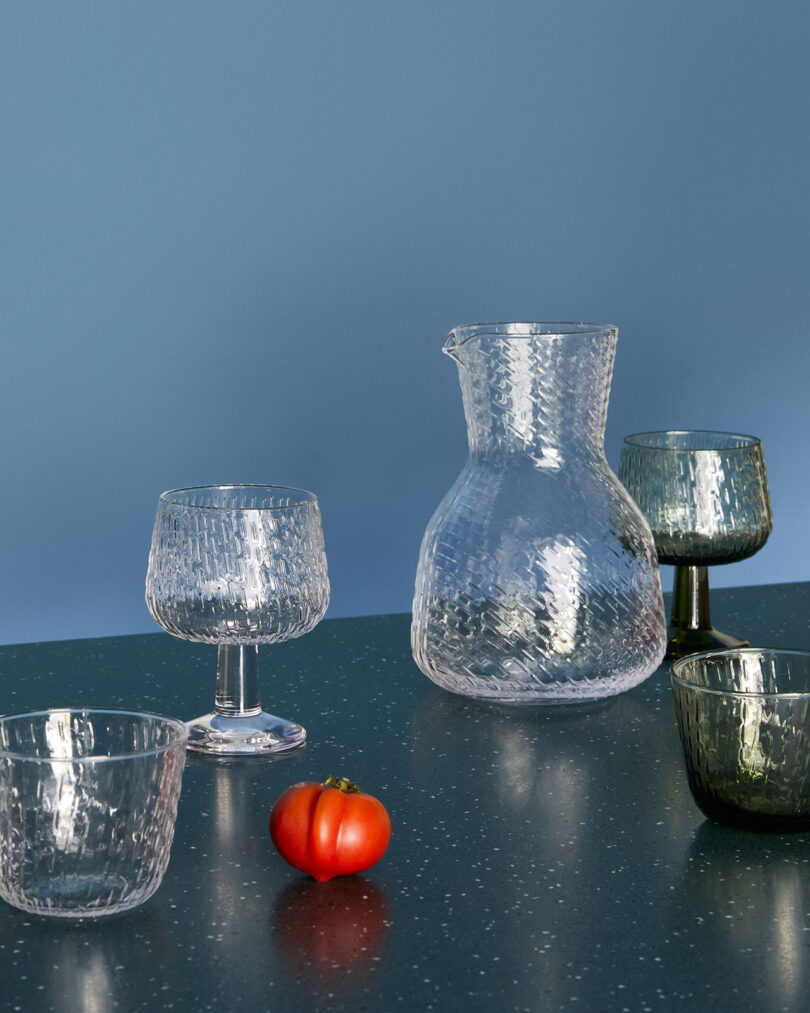 styled setting with clear glass tumblers, goblets, and carafe