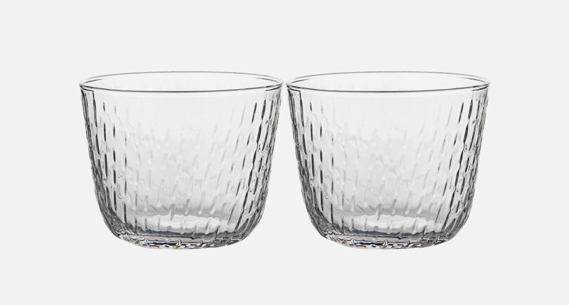 two clear glass tumblers on white background