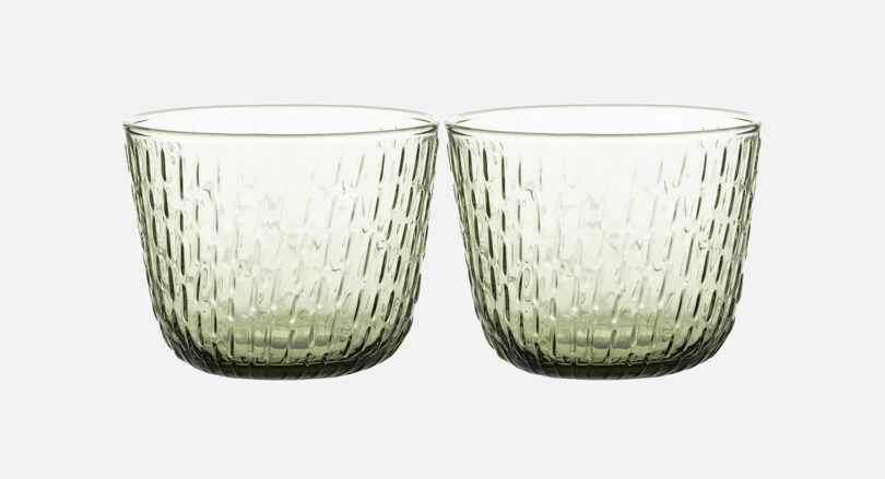 two clear glass tumblers on white background