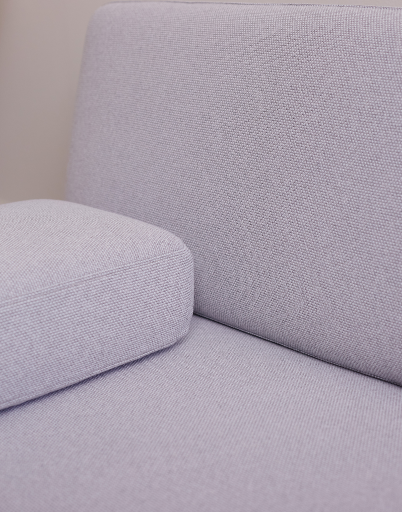 A corner detail on the light grey spoke sofa
