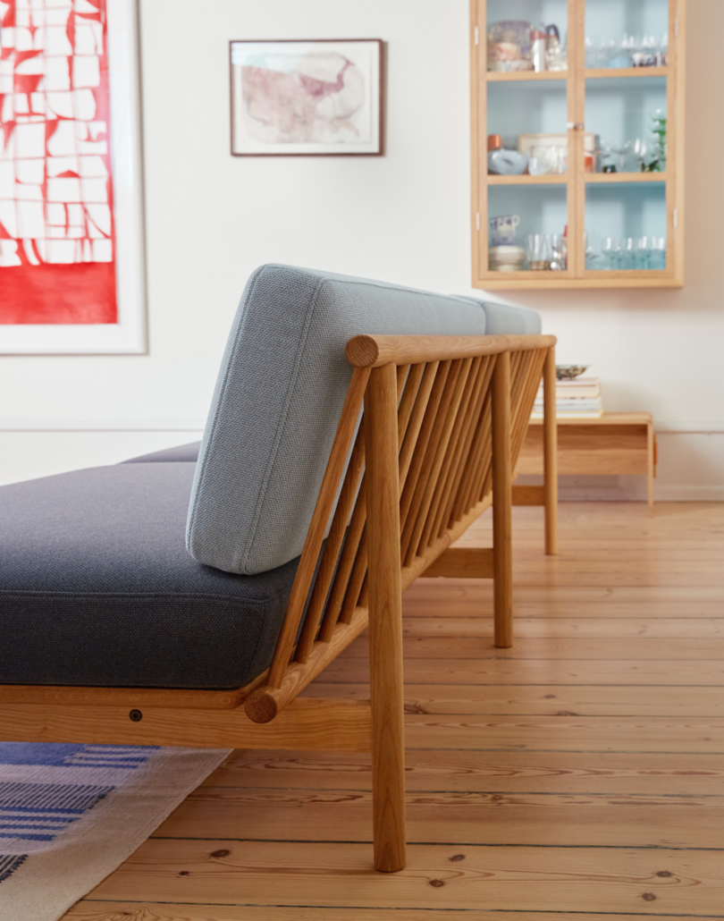 The spoke sofa seen from behind emphasising its wooden spokes