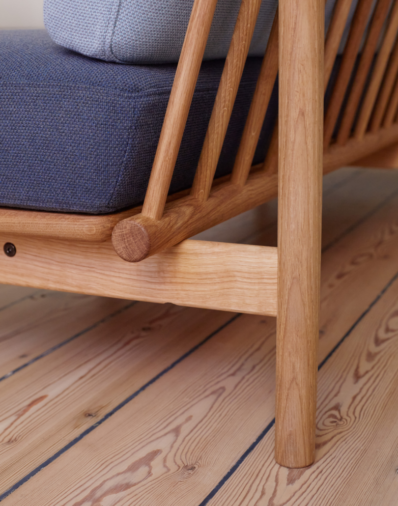 A detail of the rear corner of the spoke sofa showing the wooden spokes that comprise its back