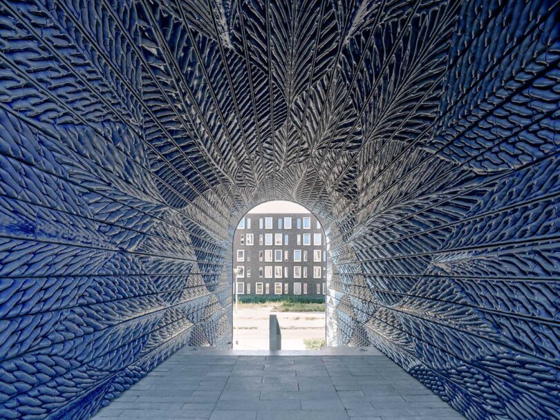 inside a tunnel clad in bright cobalt blue texture relief tiles