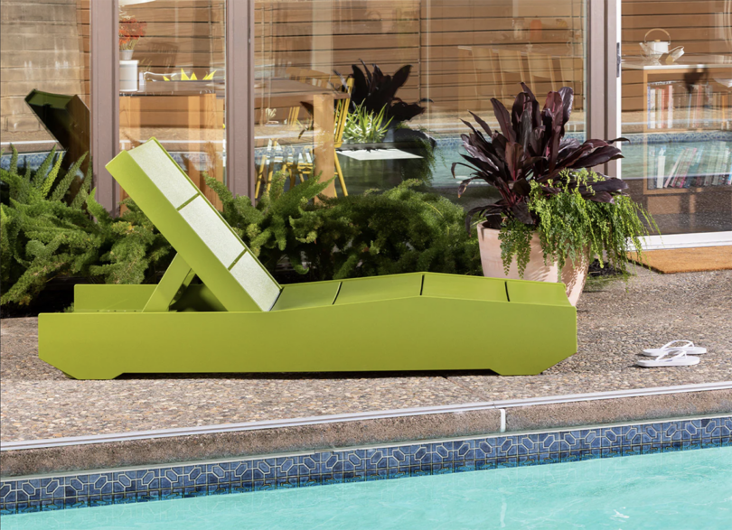 minimal neon green chaise lounge next to a pool