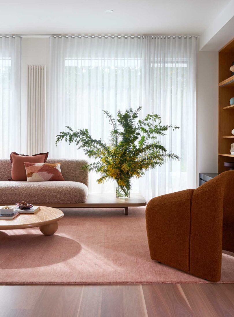 partial interior view of modern living room with tonal furnishings in pink shades