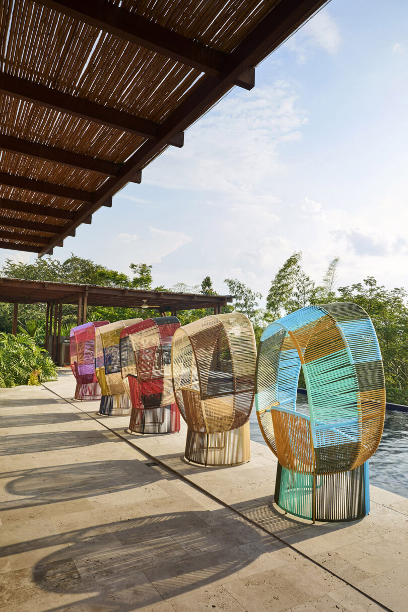 five multicolor woven chairs with hoods outdoors