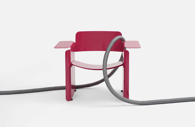 red bent aluminum armchair on white background