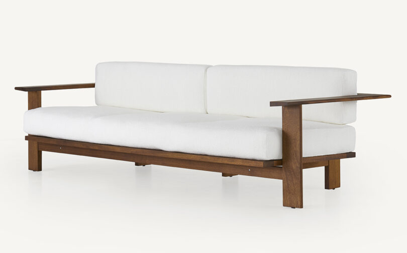 wood framed outdoor sofa with white upholstery
