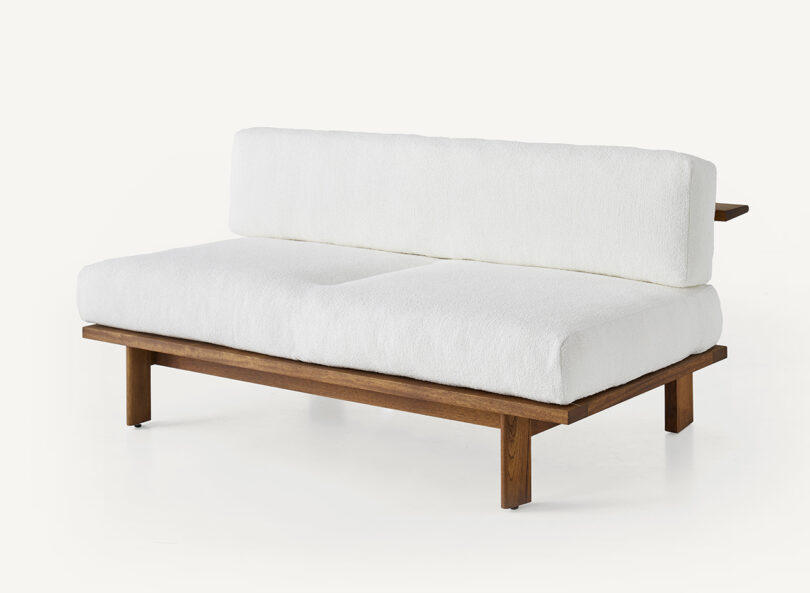 wood framed outdoor loveseat with white upholstery