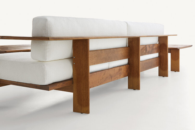detail of wood framed outdoor sectional sofa with white upholstery