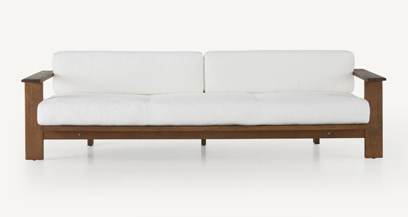 wood framed outdoor sofa with white upholstery