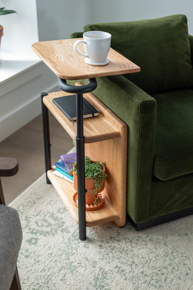 angled down view of narrow wood and black metal side table with rotating tabletop for accessibility