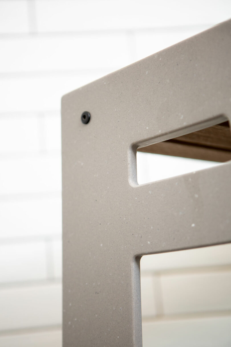 closeup side view of light gray shower seat