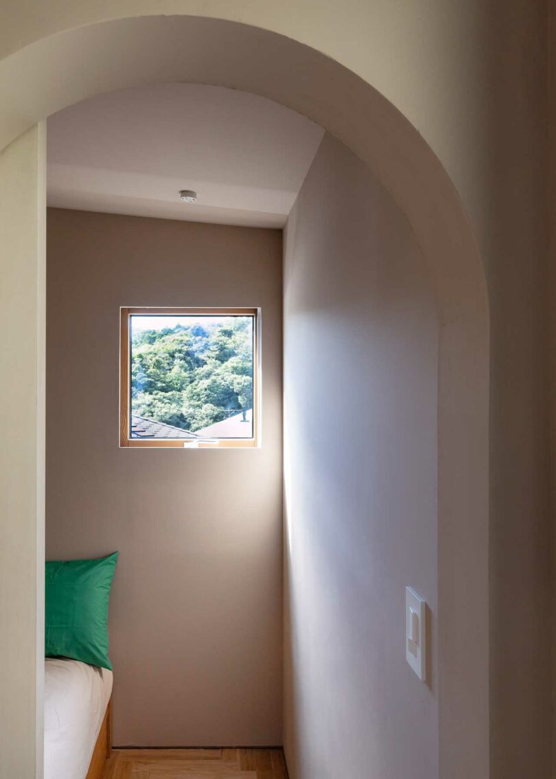 partial view into bedroom through arched doorway