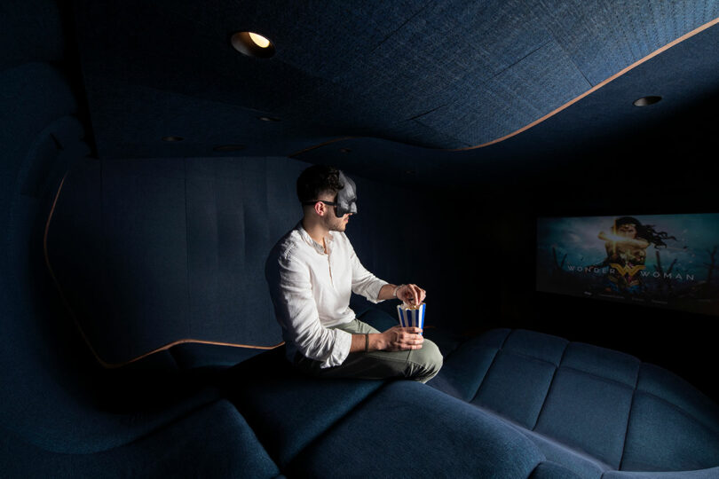 masked man sitting on wavy home theater seats