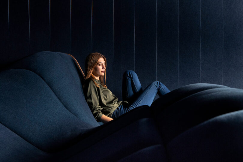 woman leaning back seating on wavy home theater seating