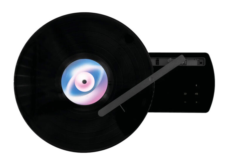 Overhead perspective of Coturn record player in black with unlabeled album on play.