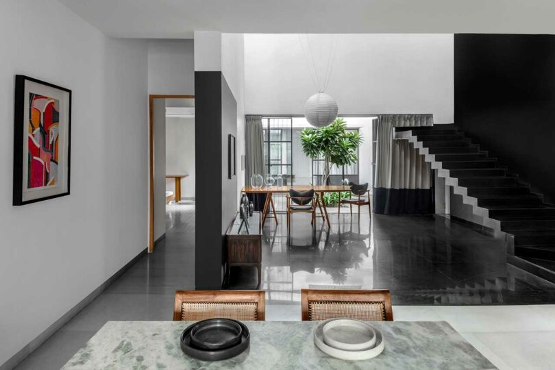 interior shot of modern house with black and white walls and floating black staircase