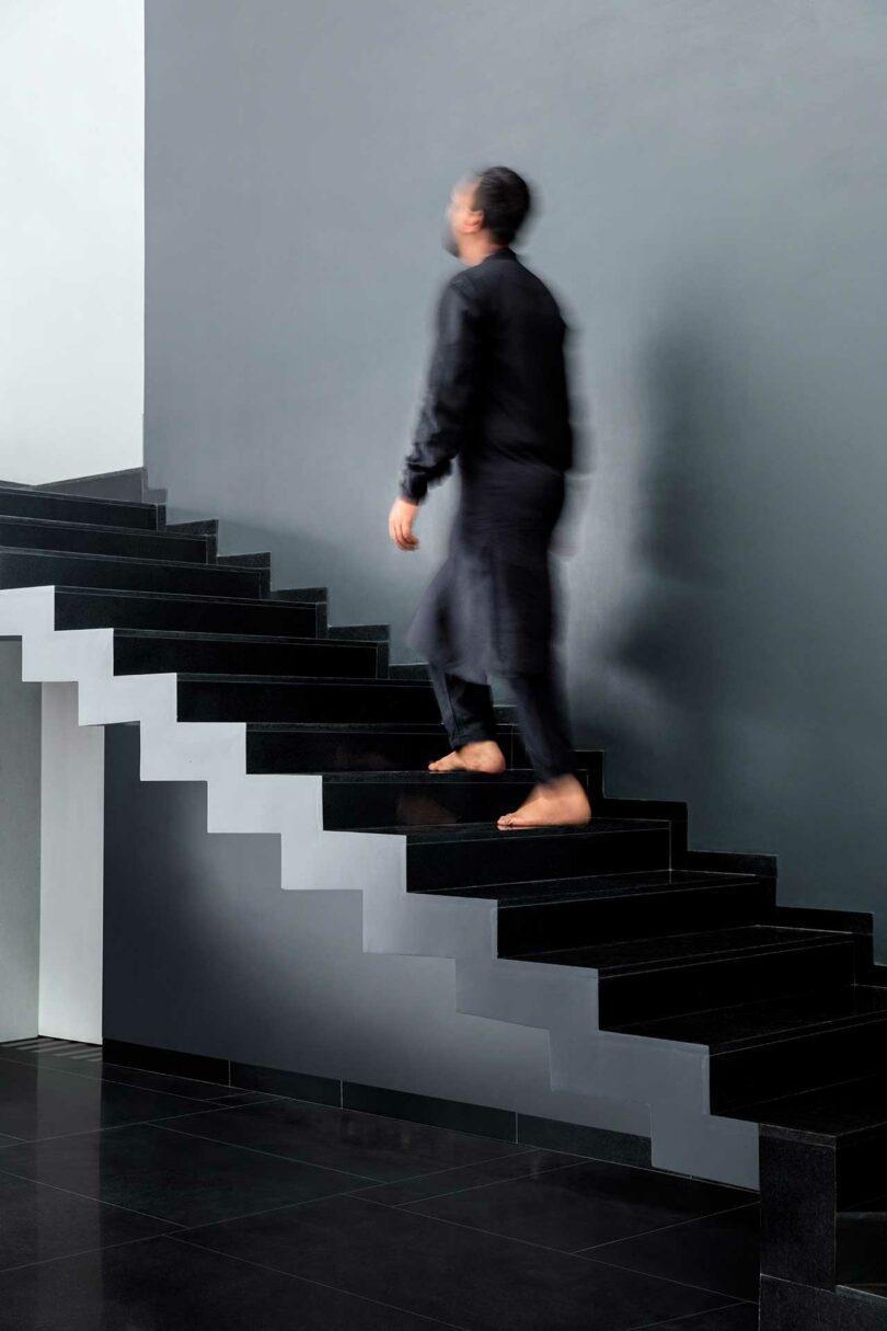 interior with black wall with black floating staircase