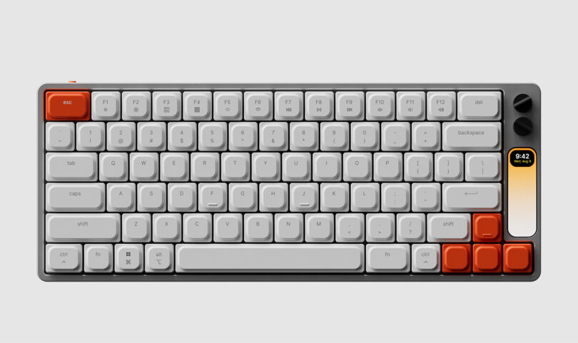 Full size overhead render of The Knob keyboard. Upper right hand ESC key and four arrow keys are in orange, rest of the keycaps are all white, with two black rotary knobs in the upper right hand corner of the keyboard.