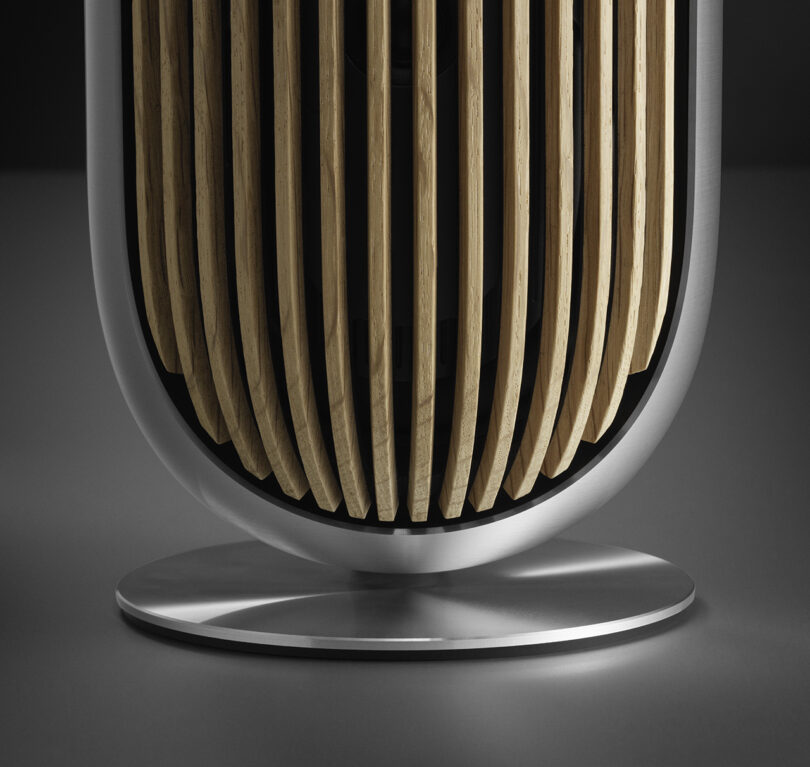 Bottom half the Beolab 8 and its aluminum one piece design alongside its circular metal pedestal base.