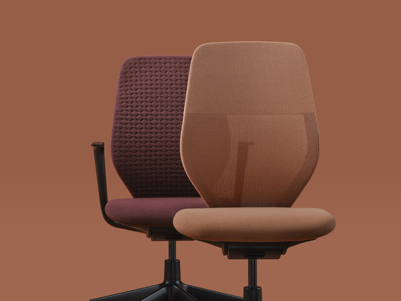 Two Vitra ACX task chairs set against a salmon-orange hued background. One on left has arms with a knit pattern cover, the other without arms in a lighter salmon shade.