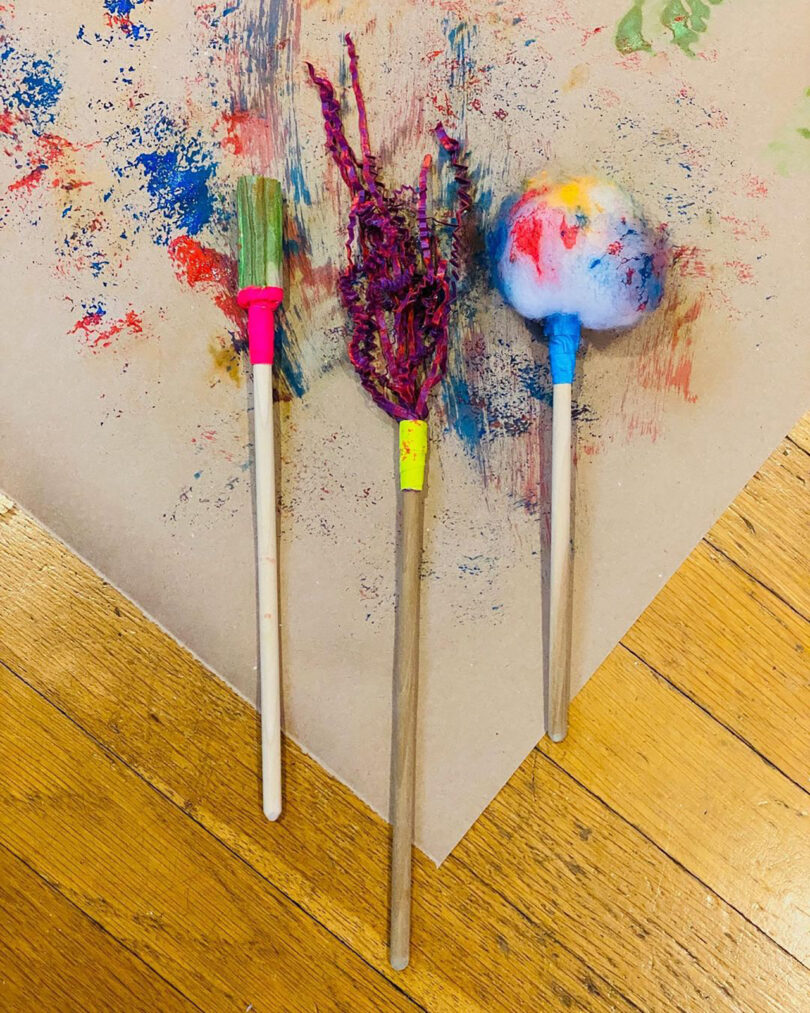 three colorful homemade paintbrushes