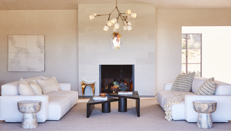 styled living space with central fireplace and matching white sofas