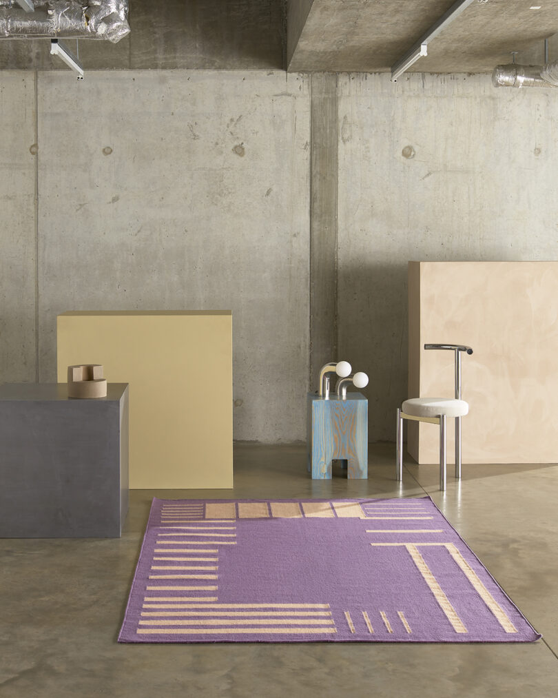 rectangular purple and peach rug in studio space