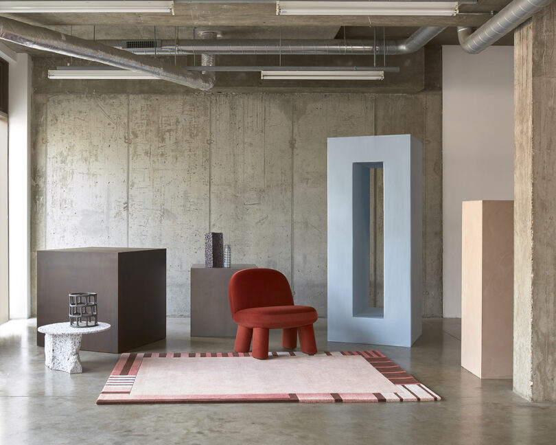 rectangular pink and red rug in studio space