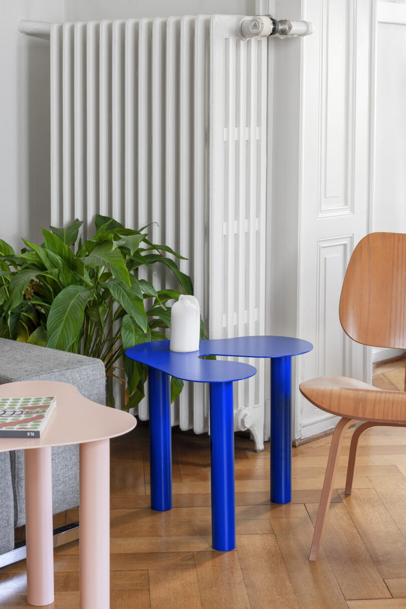 two pink and blue occasional tables in a styled living space